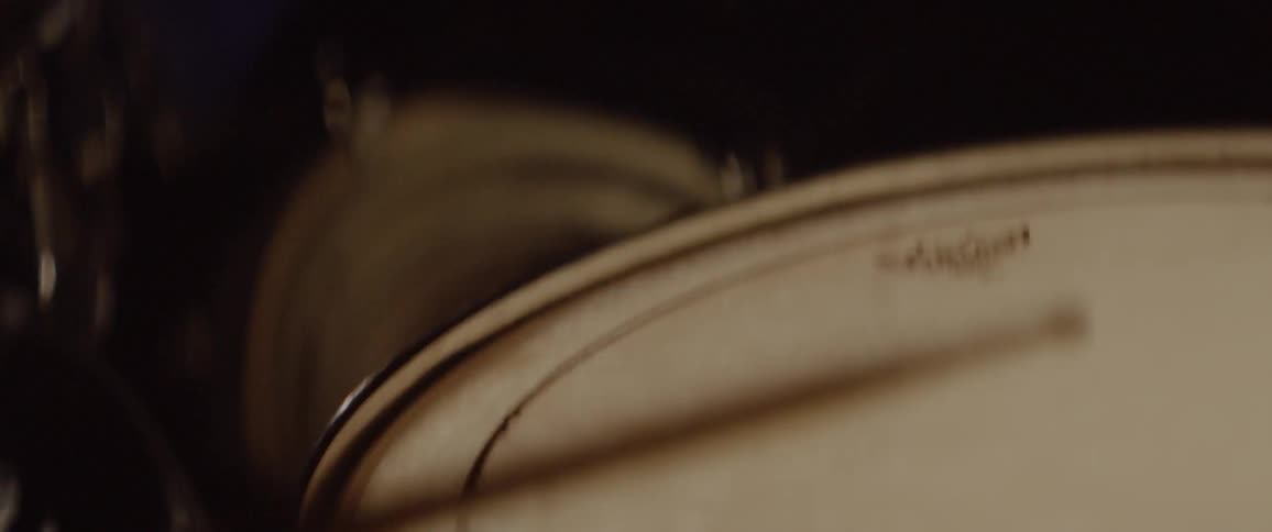 Drum sticks hit a snare drum