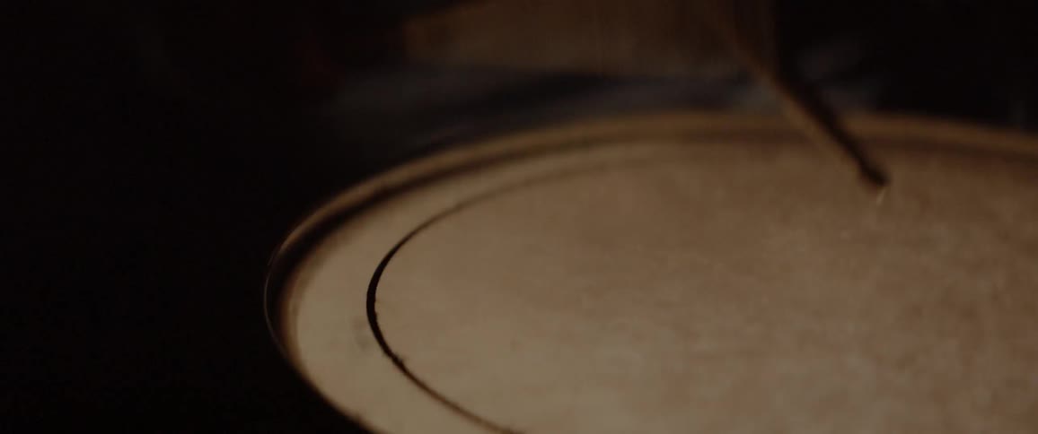 Pair of drumsticks tapping on a drum