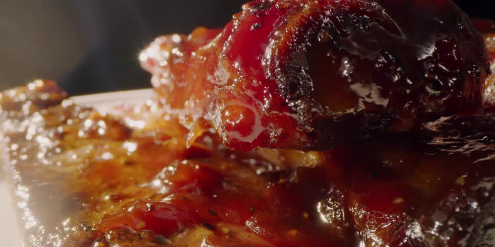 There is glazed meat on the plate