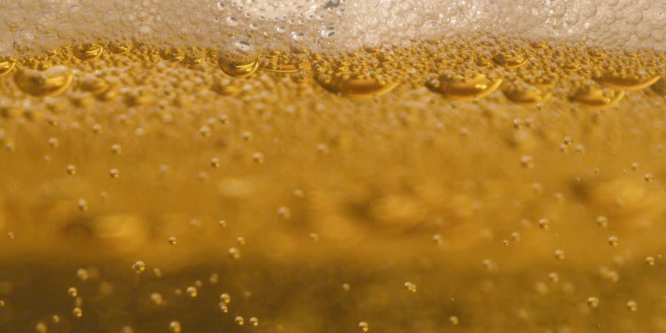 Brown bubbles float up in the liquid