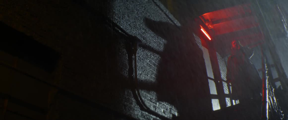 A man smokes a cigarette outside while it rains