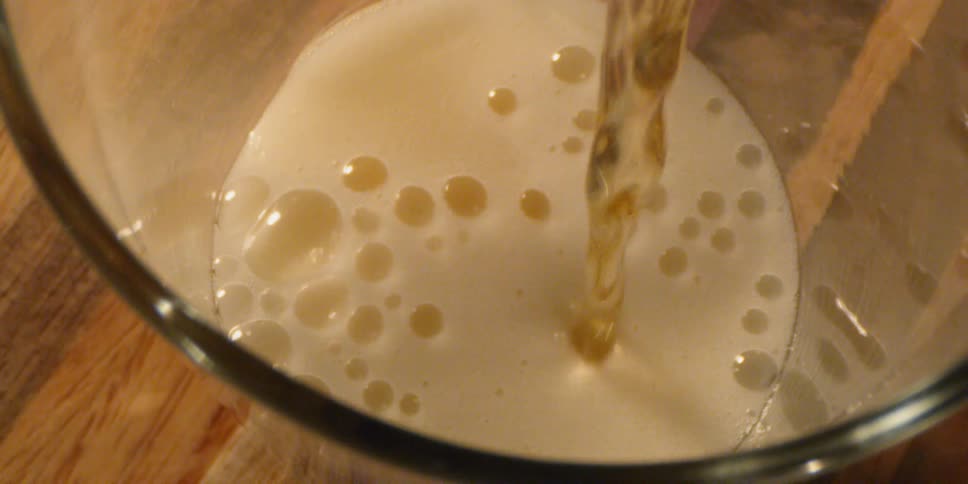 A drink is poured into the glass