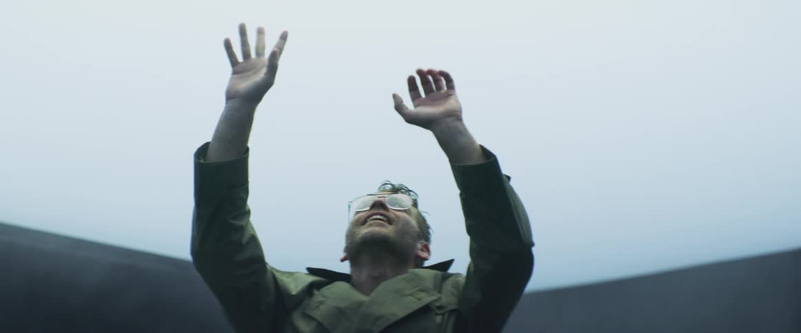 Man looking up a the sky on a foggy and rainy day