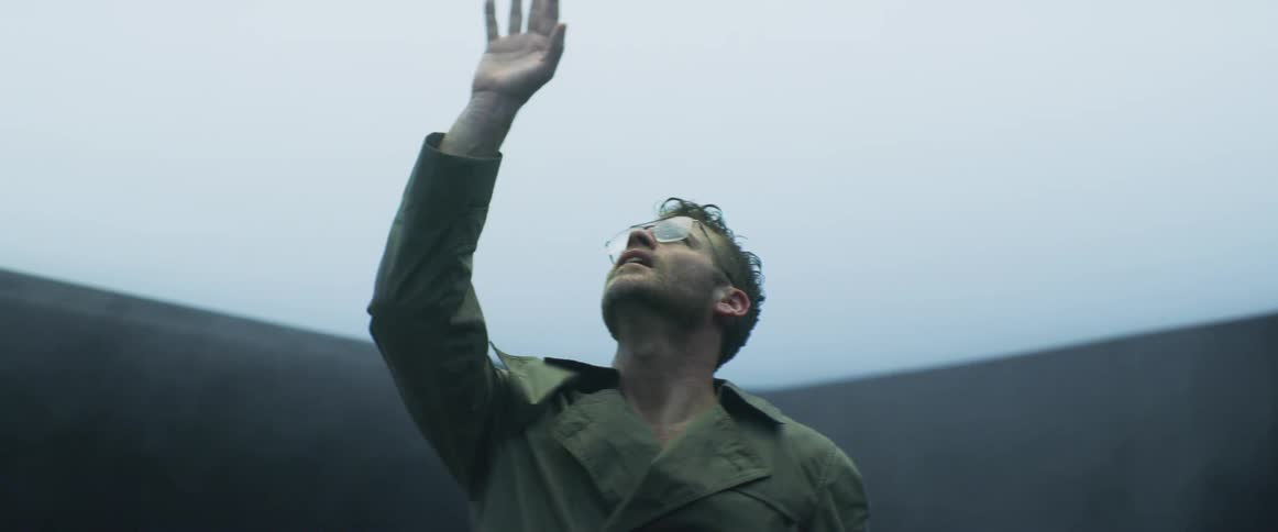 A man raises his arm up into the air