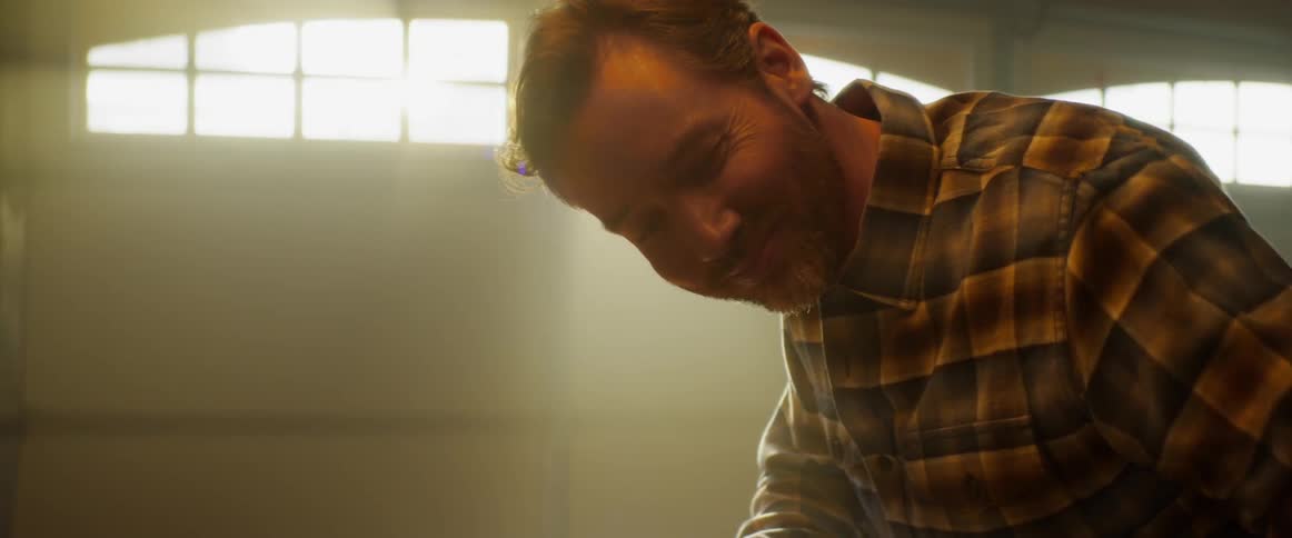 A man works in a dusty garage