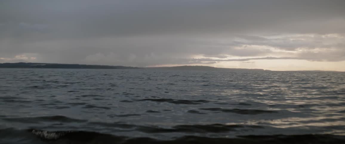 Water flows on a lake at sunset