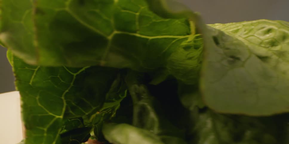 Vegetables are sitting on a cutting board in daylight