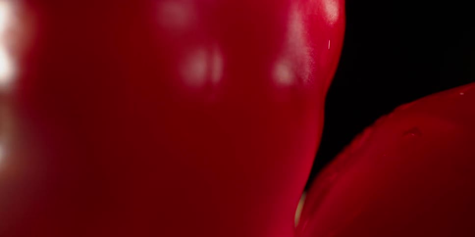 Red bell pepper on a cutting board sliced in half