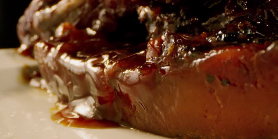 Sauce drips down the side of cooked meat