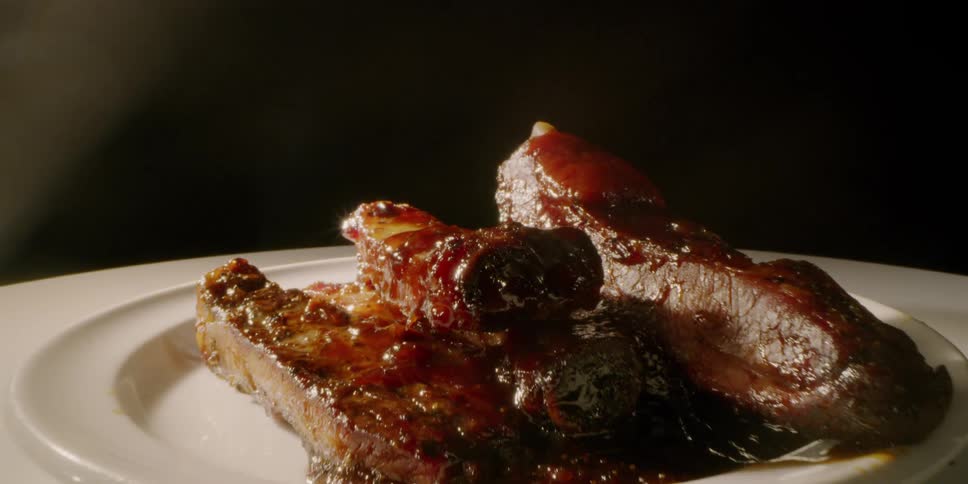 Cooked meat sits on a white plate