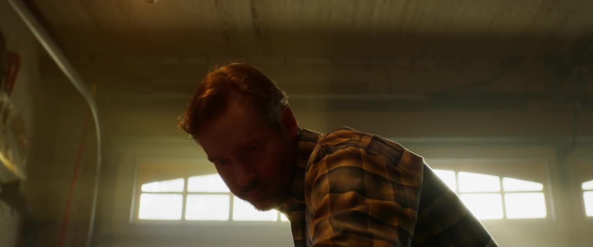 A man works in a dusty garage