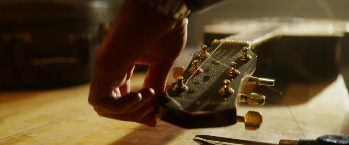Man Refurbishing Guitar