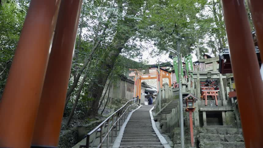 A person walks through the torii gates at Fushimi Inari shrine