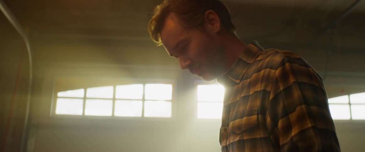A man works in a dusty garage