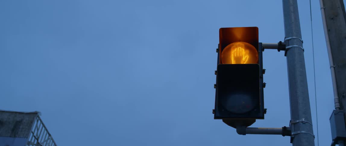 The light on the stop signs flashes red to green