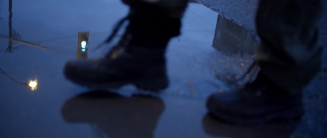A car passes next to a road puddle