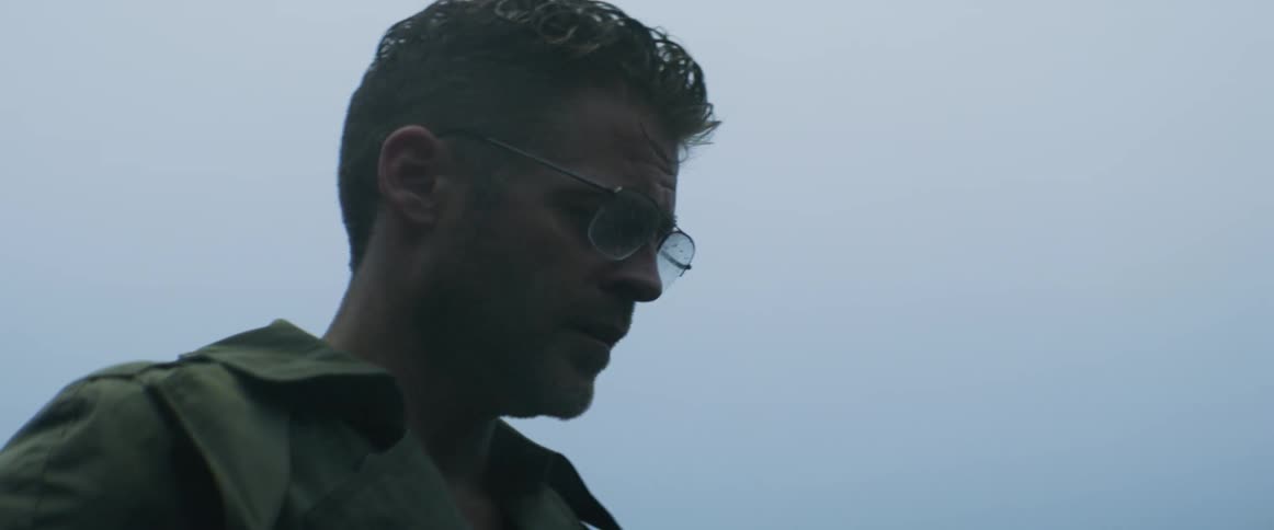 A man stands outside in mist and rain