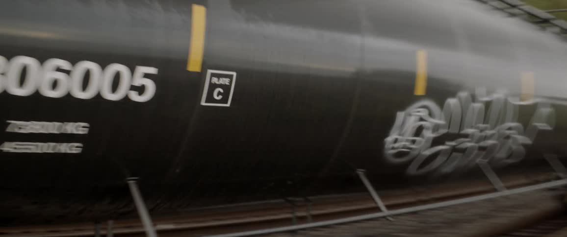 Train travels on a track near a staircase