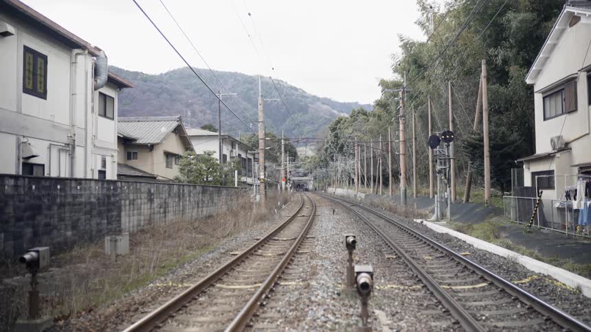 Train tracks in a village during the day