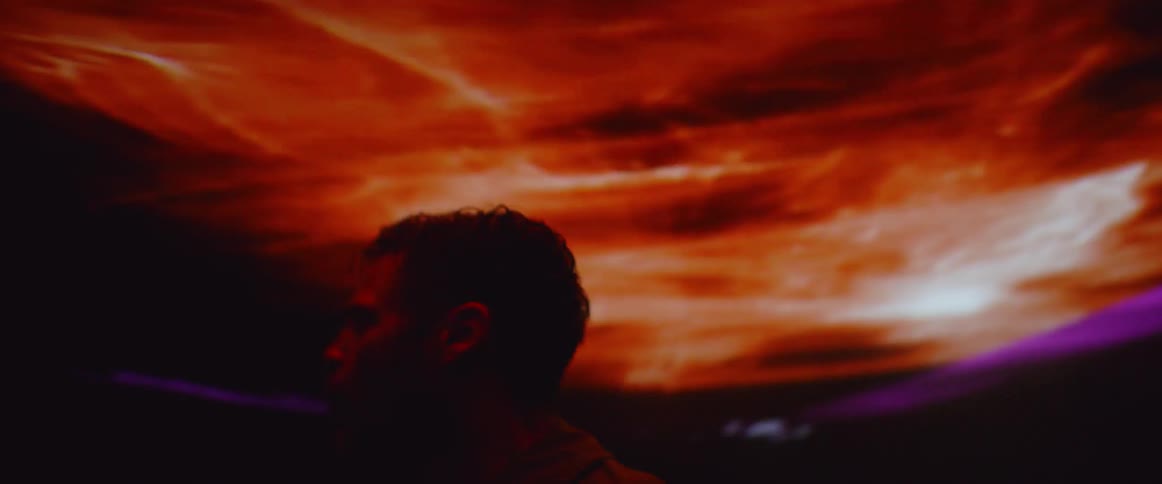 A man screams in the dark with flashing lights