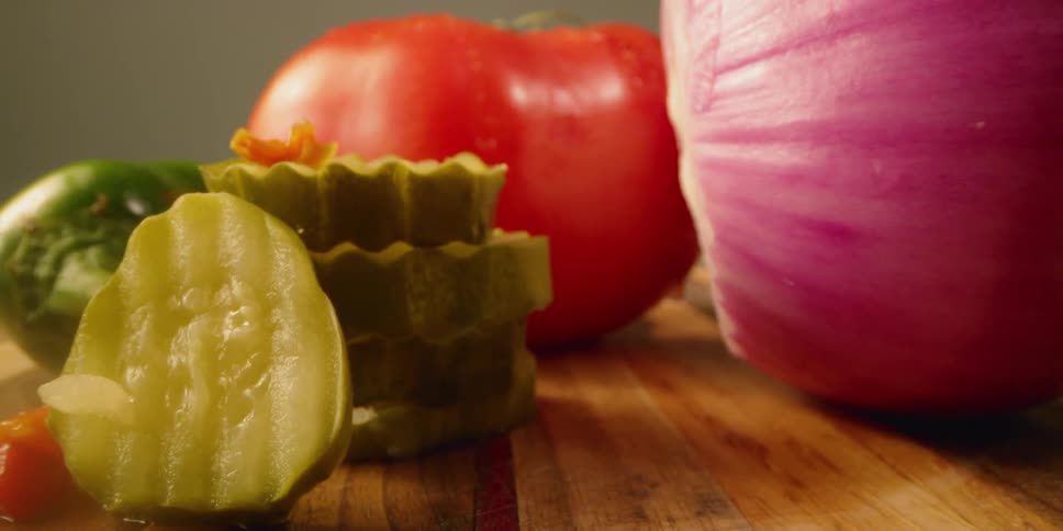 Vegetables sit on a wood cutting board