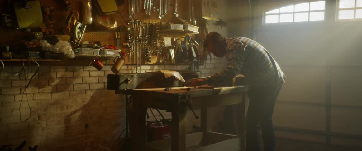 Man works at a workbench in a garage