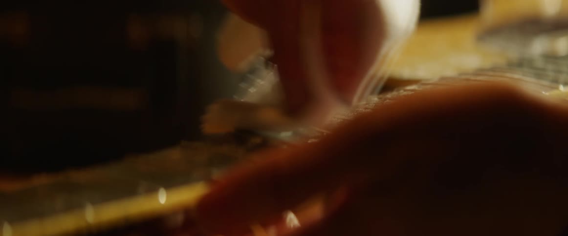 Person cleaning a guitar