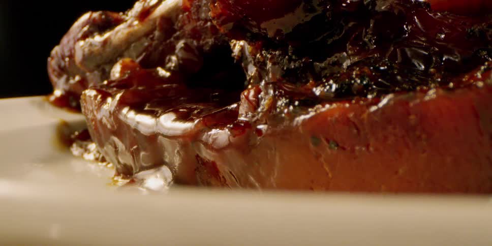 The food on the plate is covered in sauce