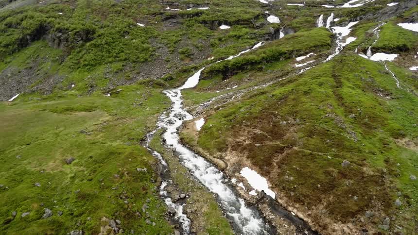 A view of a mountain stream winding through the hillside