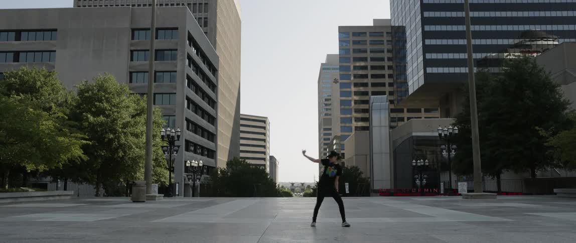 A person is dancing in the empty city street