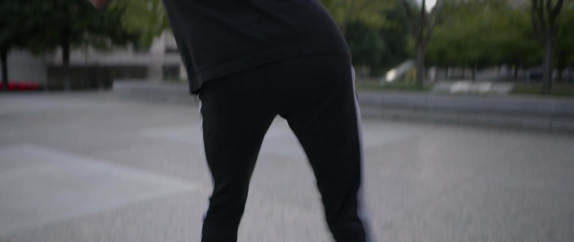 Man dancing in a city street in the afternoon