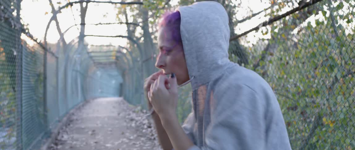 Woman practices punching outside in a fenced in area