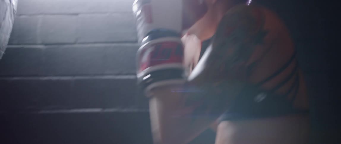 Woman hits punching bag