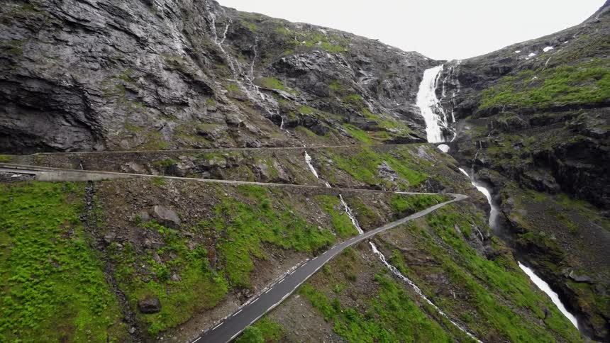 Mountain roads near a waterfall in the daytime