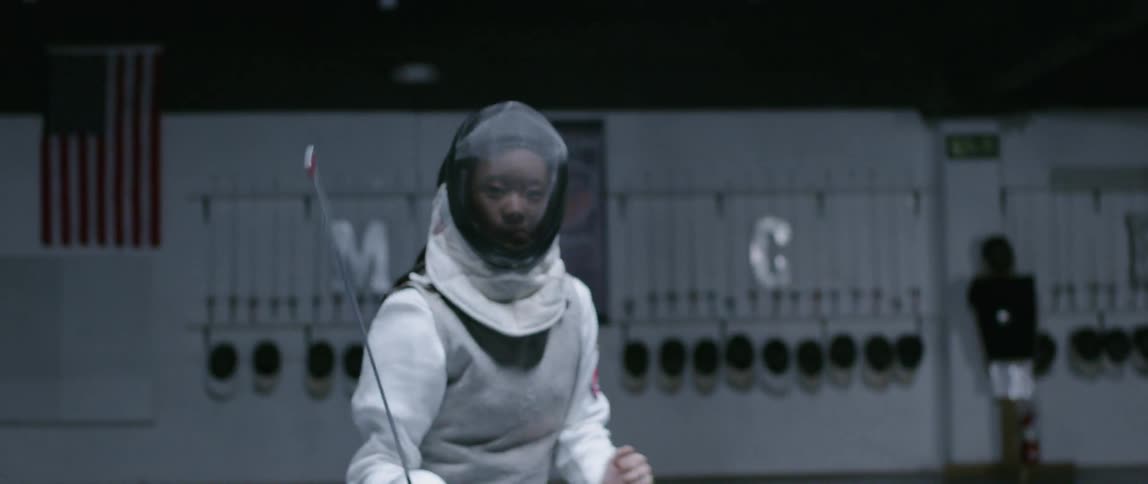 Woman fencing in a gym