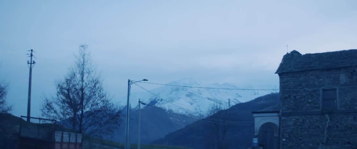 The small town leads to a snow covered mountain