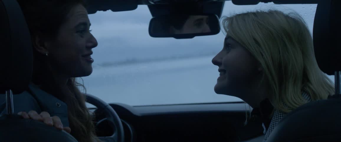 Couple talking in car by the lake shore