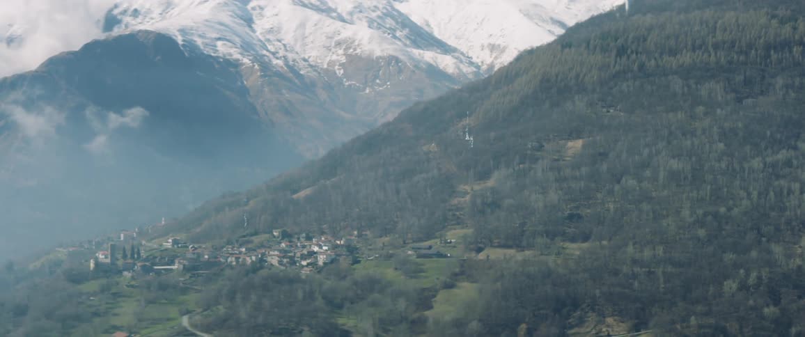 A town sits at the bottom of a large mountain