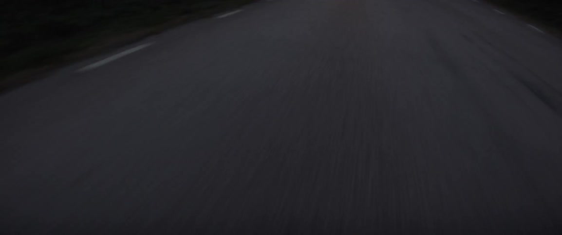 The grass is on the side of the long road