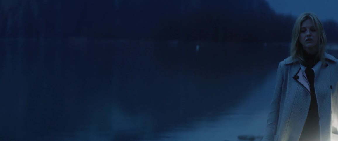Women in front of a car at dusk in rain