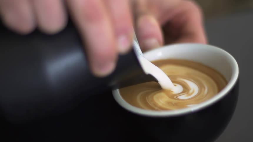 Milk foam is poured into coffee