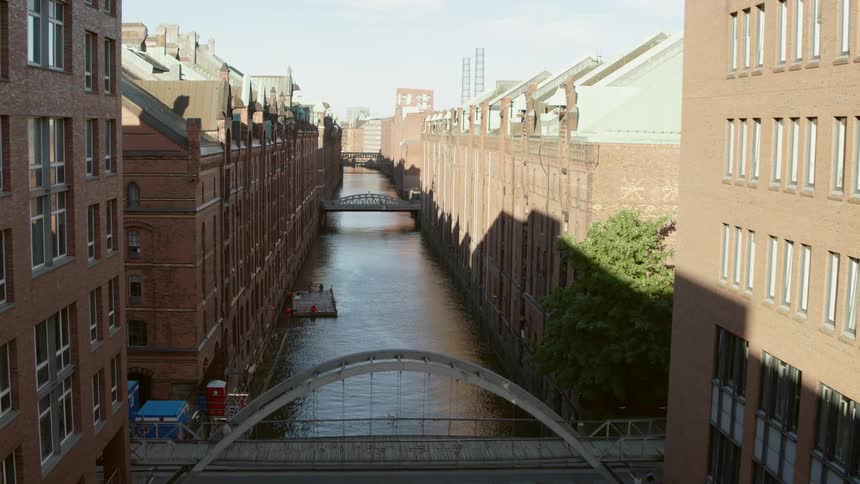 A person walks over the canal bridge in Hamburg Speicherstadt