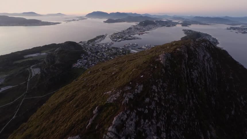 A coastal town near a mountain in the morning