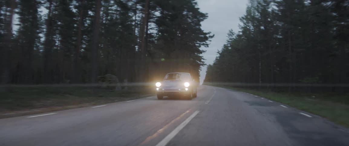 Car travels down a highway near the trees