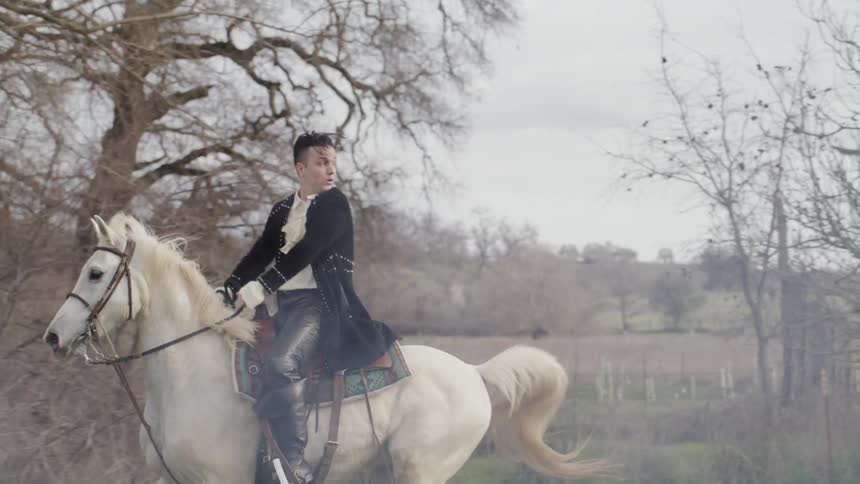 Man in period costume rides horse