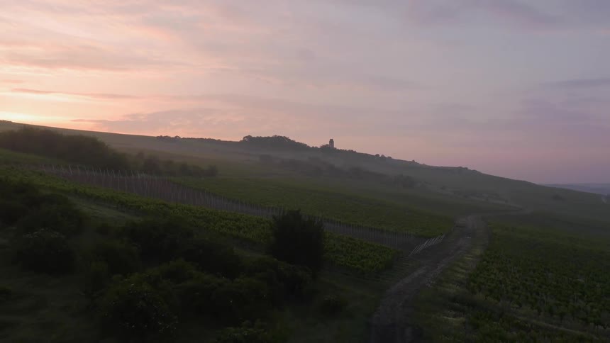 Sunrise over hillside farmland