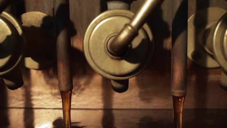 Liquid pours from a machine into a reservoir