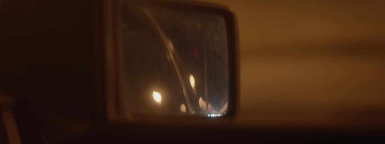 Car driving through the city at night