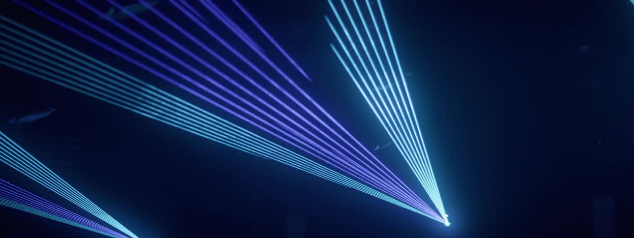 The lights shine around in the foggy club