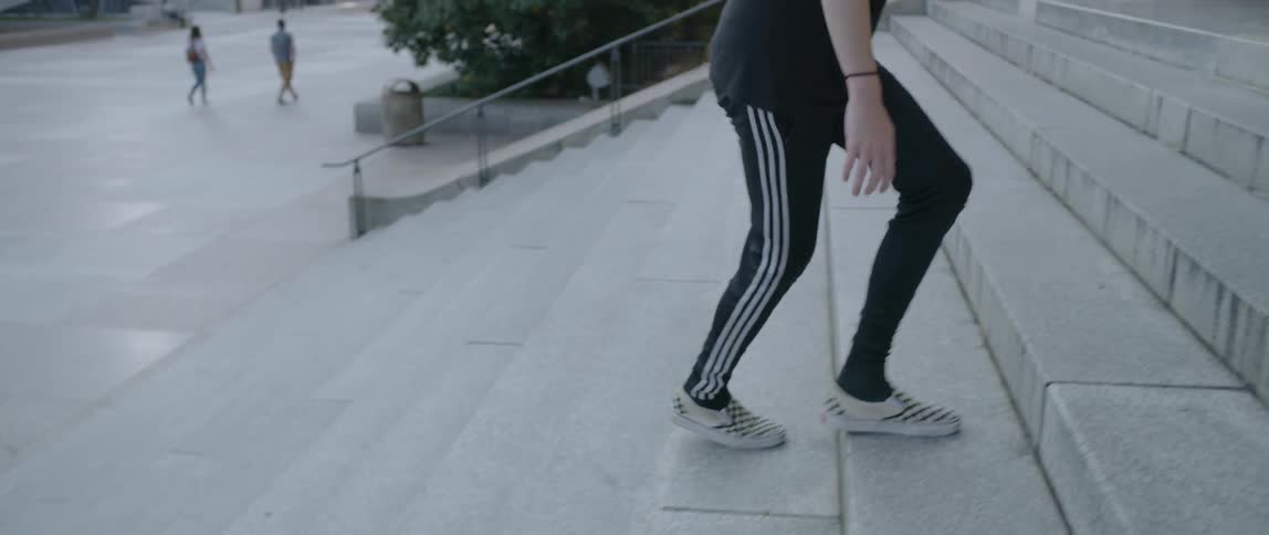 A man dances as he walks up the steps